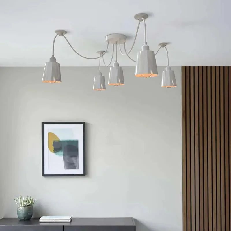 Matte white 5-way spider pendant light with five adjustable cone shades and fabric-wrapped cables hanging from ceiling rose