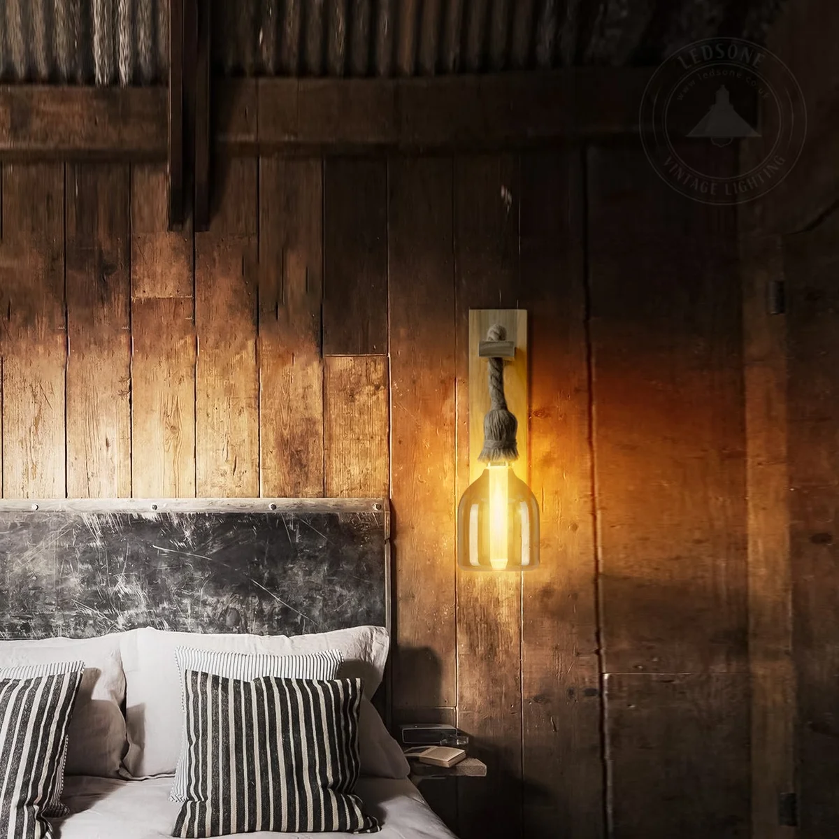 Vintage LED bulb with amber glass and exposed filaments glowing warmly, fitted with an E27 Edison screw base