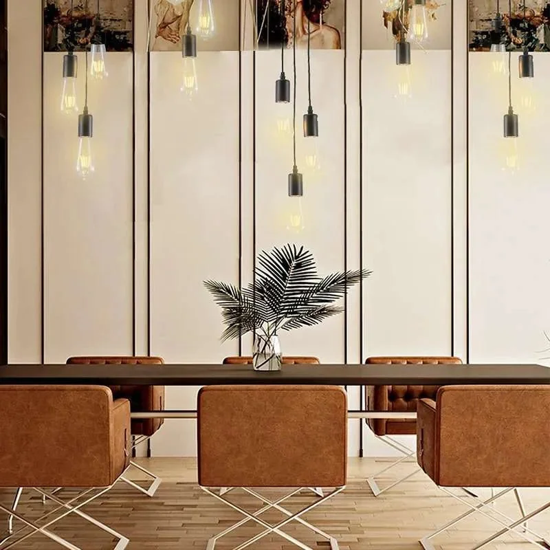 Black vintage industrial 3-way pendant light with adjustable height light cables and metal ceiling rose against white background