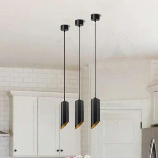 Modern black gold pendant light with cylindrical tube shape, matte black exterior, and warm gold interior finish
