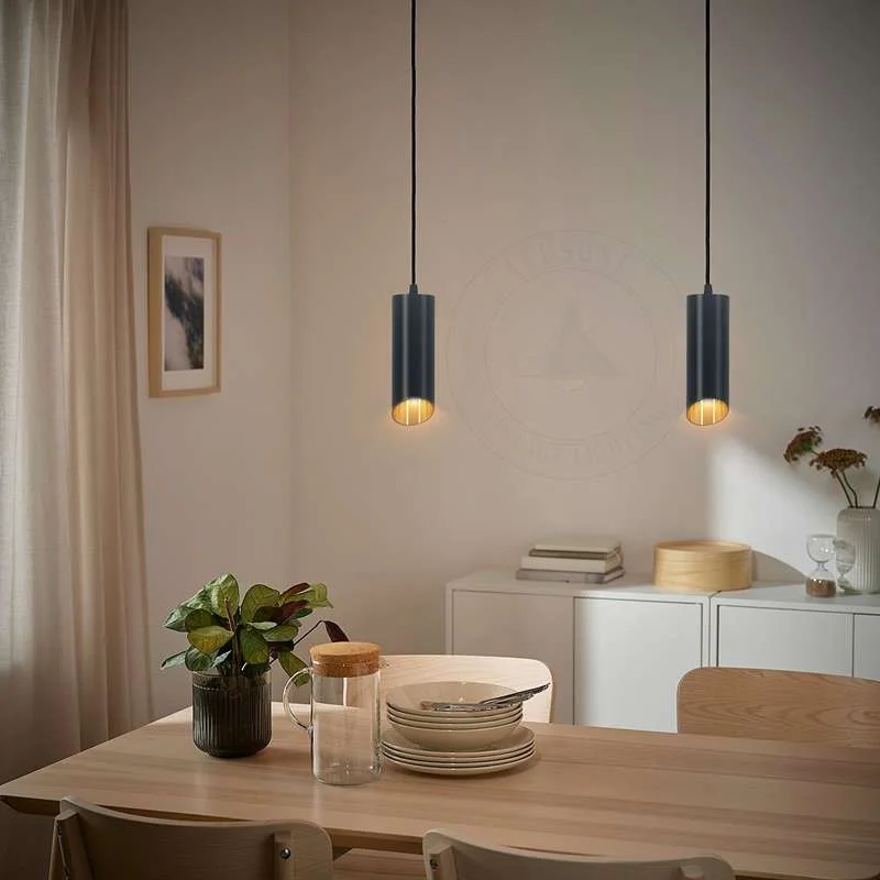 Black gold pendant light with matte black exterior and gold inner finish, cylindrical tube shape, hanging by adjustable cable