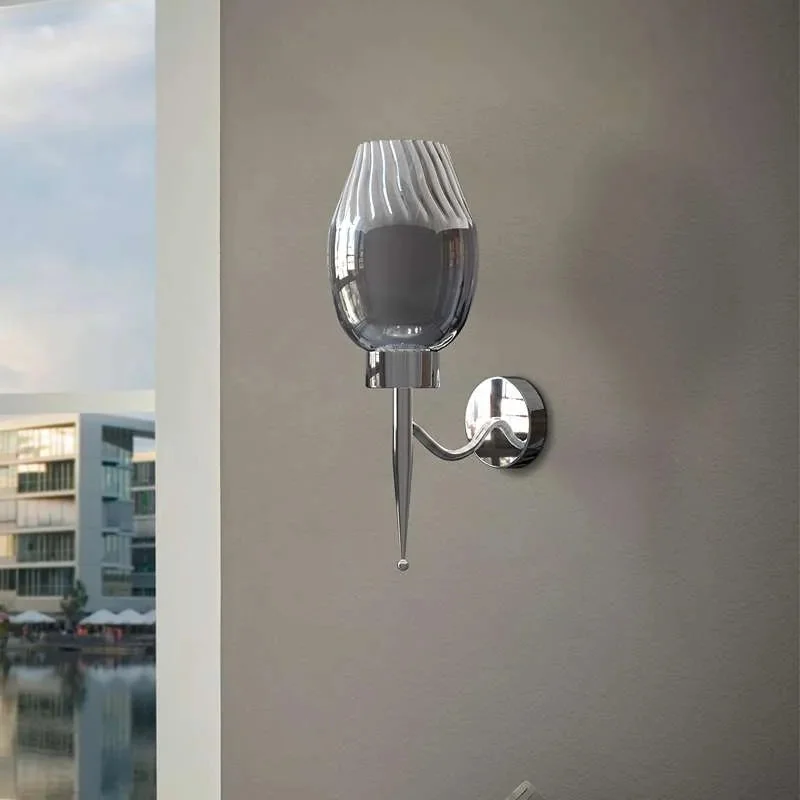 Modern chrome wall sconce with smoky glass shade, 16cm height, mounted on a white wall, ideal for indoor lighting.