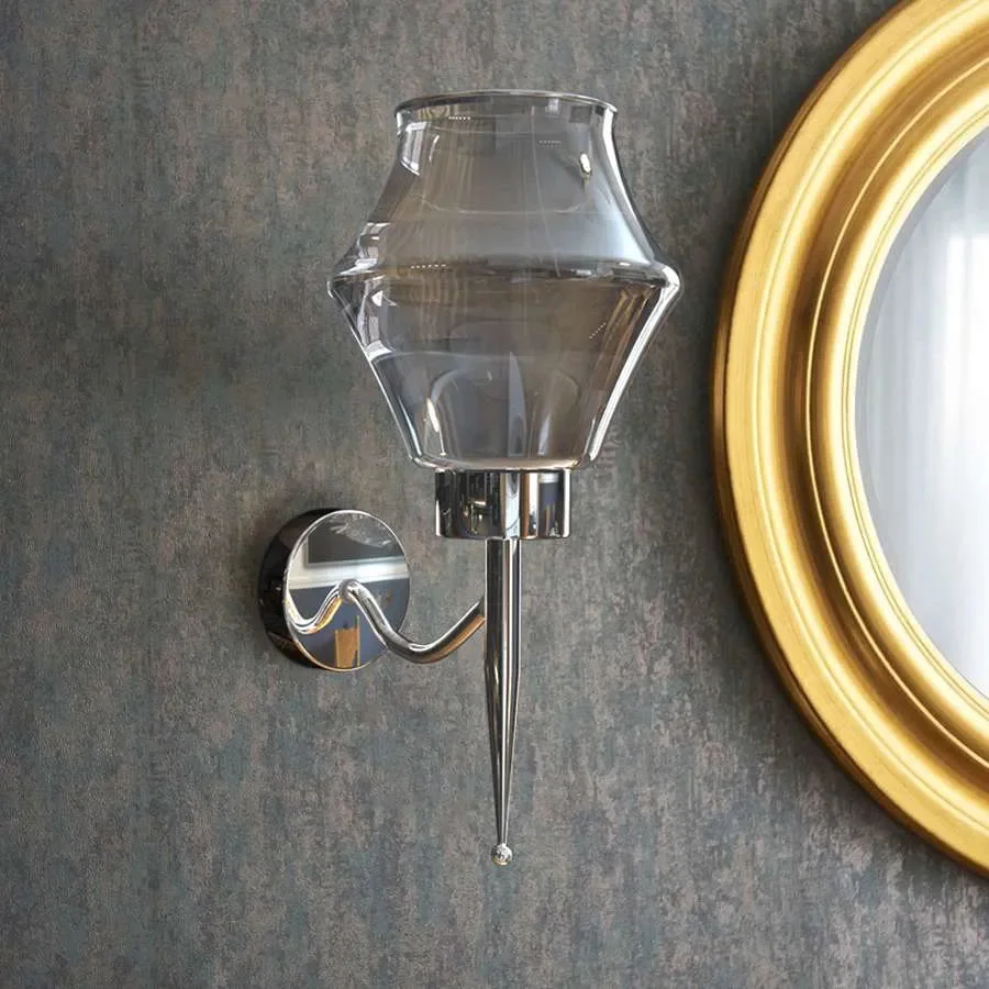Smoky gray glass shade energy efficient wall light with chrome plated base mounted on a white wall, modern style