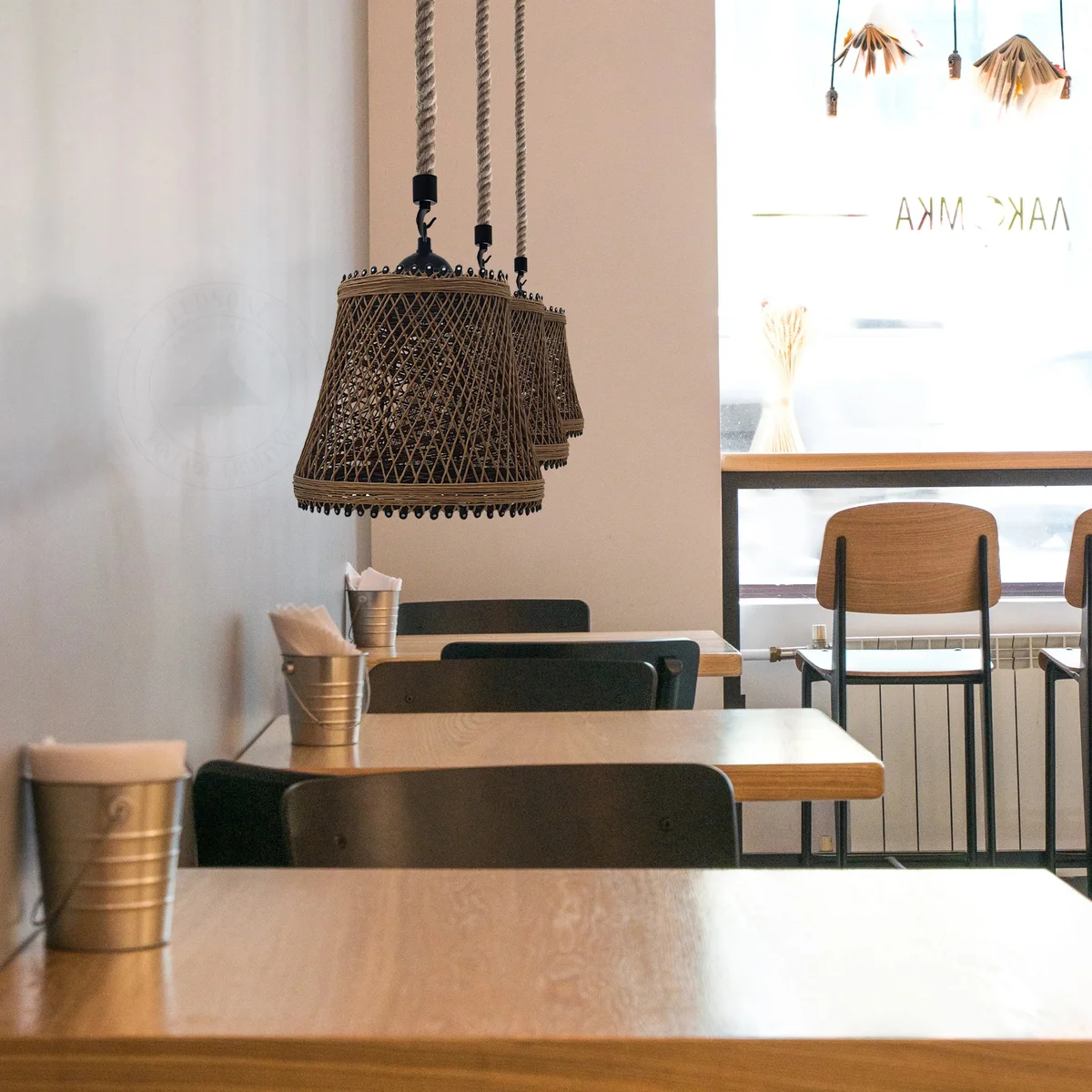 Vintage ceiling pendant light with metal cage shade and hemp rope hanging from ceiling in loft style design