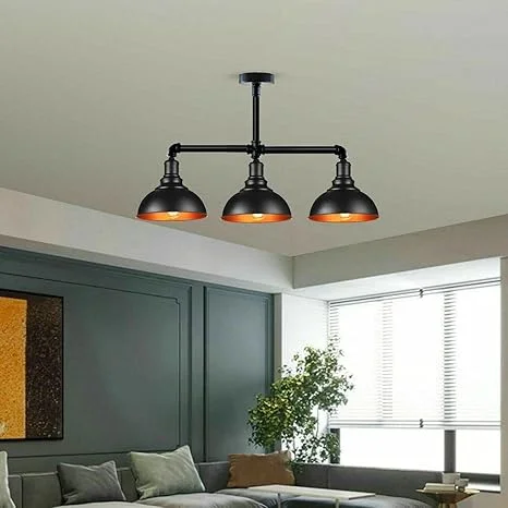 Industrial pendant light with three black metal pipe arms and E27 fittings in a steampunk style ceiling fixture