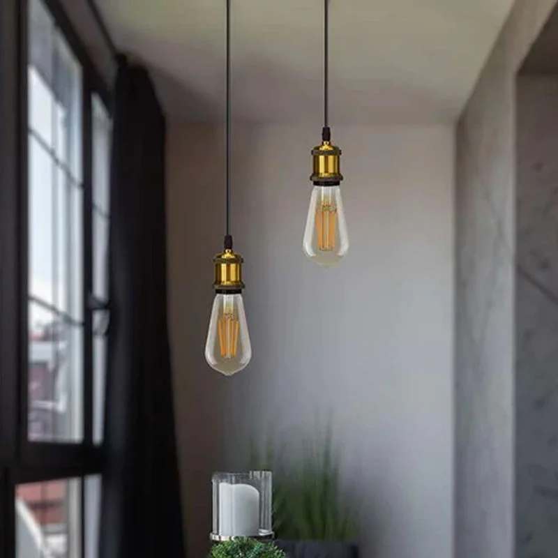 Vintage brass pendant light with yellow brass finish, adjustable cable, and E27 bulb holder hanging against white background