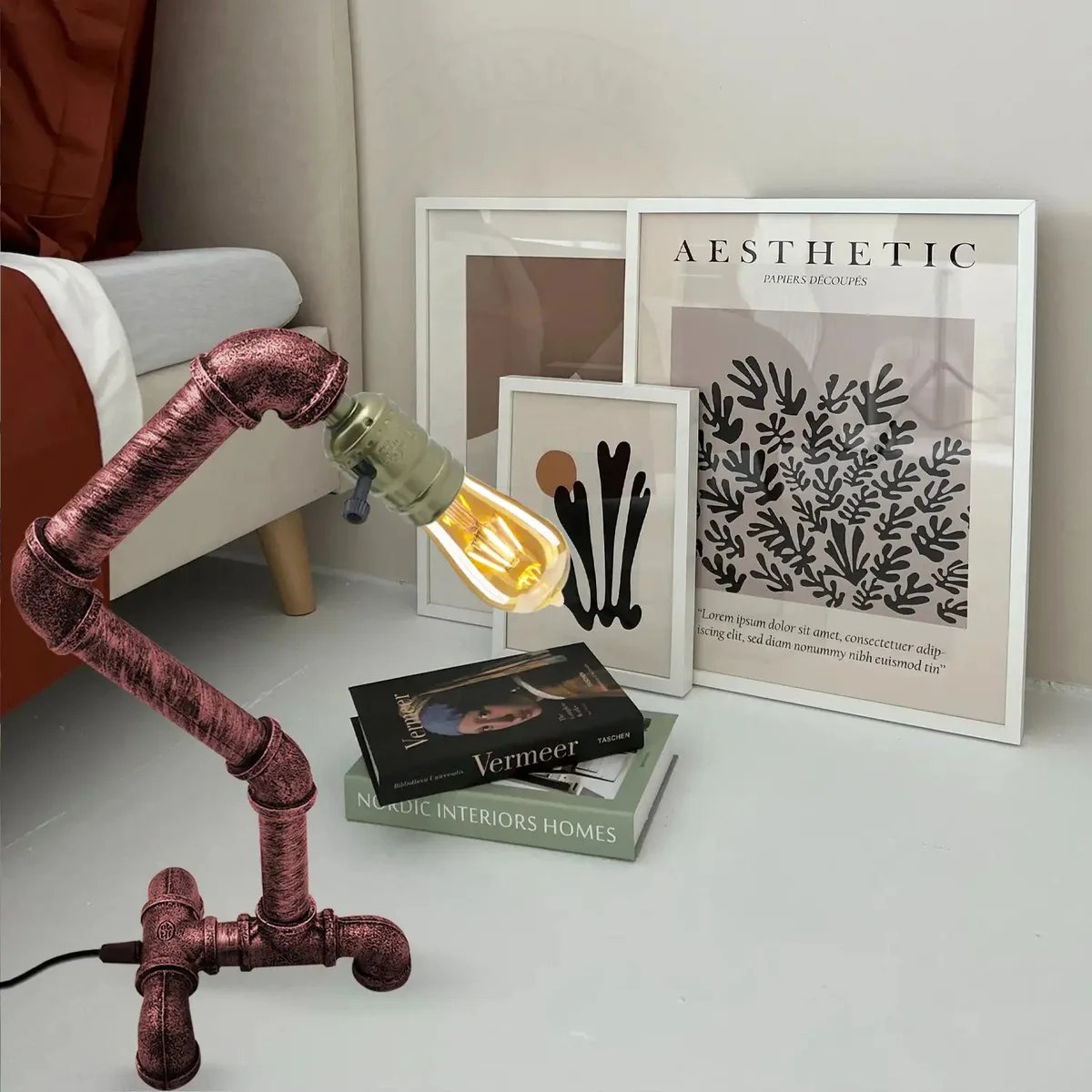 Rustic red lamp with steampunk water pipe design, dual switches, and weighted metal base on wooden surface