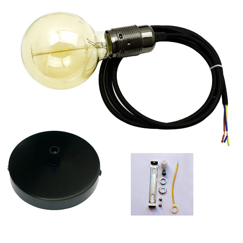 Black pendant lamp with fabric cable and glowing E27 vintage bulb hanging against white background