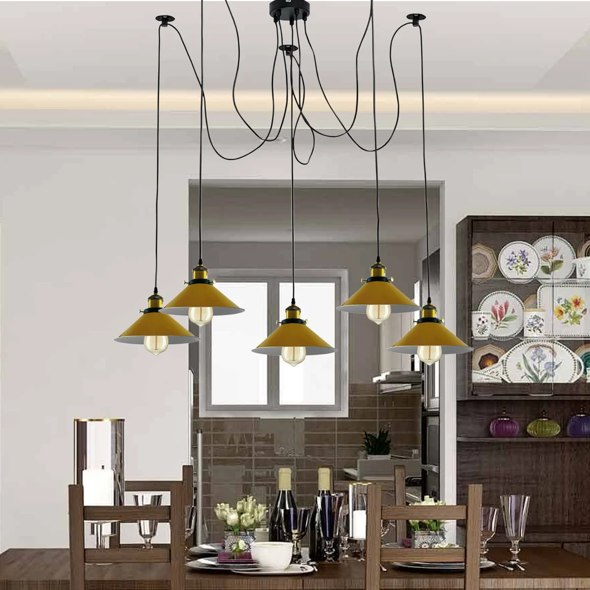Modern retro spider ceiling light with five yellow cone shades and metal braided arms hanging from ceiling rose