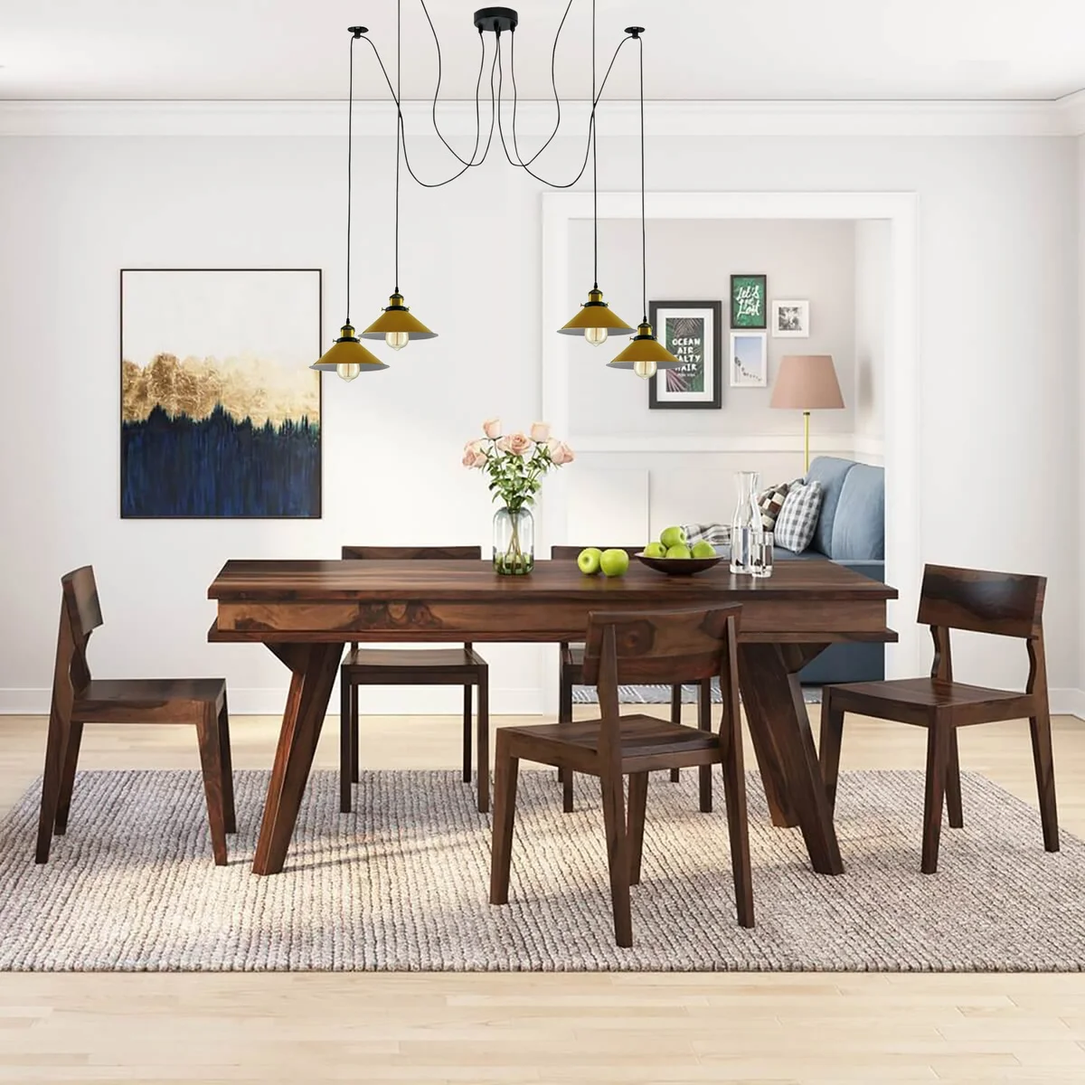 Modern retro spider ceiling light with four yellow cone shades and metal braided arms hanging from ceiling