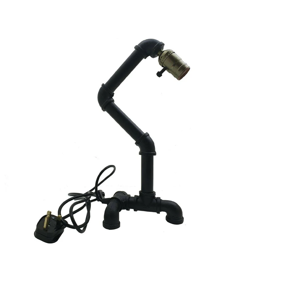 Black vintage style steel pipe E27 bulb table lamp with rust color and industrial design on wooden surface