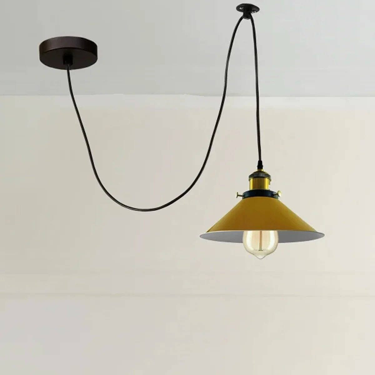 Retro spider pendant light with yellow cone metal shades and Edison-style filament bulbs hanging from ceiling