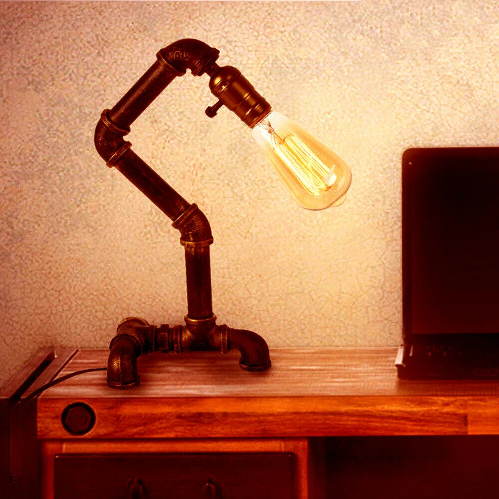 Industrial steampunk table lamp with metal water pipe design, rust-resistant finish, and E27 bulb fitting on wooden surface