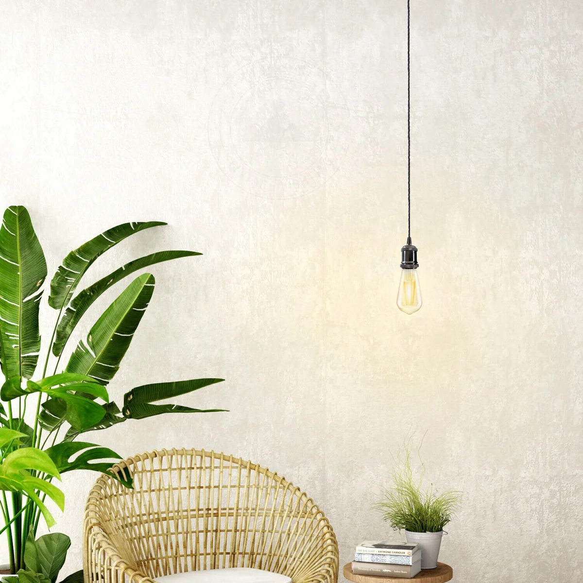 Industrial pendant light with high-polished brass holder and green twisted fabric cable hanging against white background