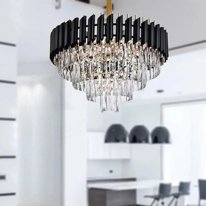 Black and gold chandelier with hanging clear crystals and black tube frame, ceiling mounted with adjustable chain