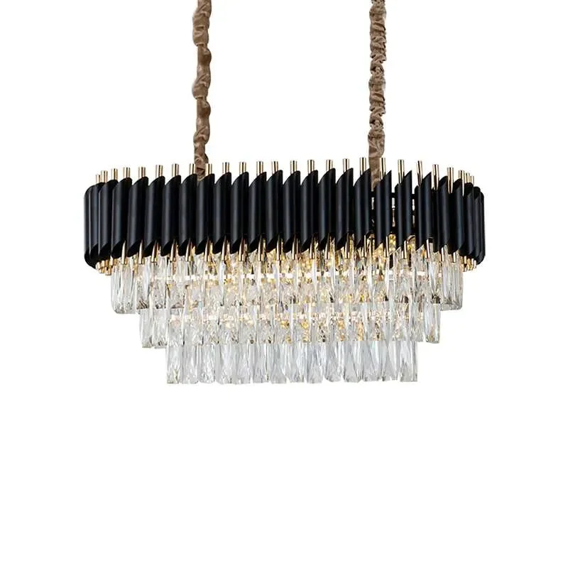 Modern black and gold chandelier with clear crystal body hanging from adjustable chain, ceiling-mounted light fixture