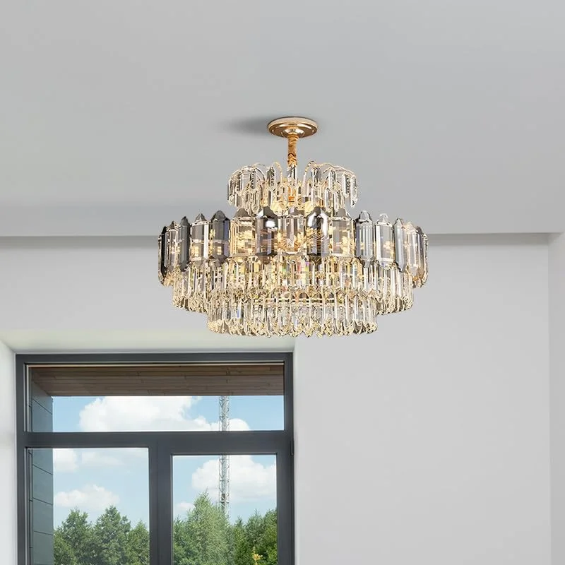 Modern multi-layered ceiling light with clear crystal tiers and aluminium frame, emitting warm prismatic glow