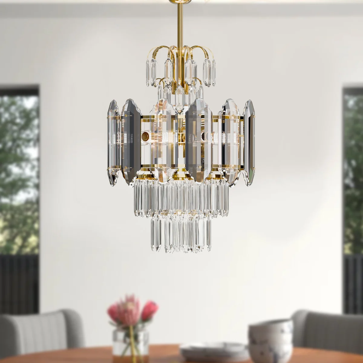 Modern crystal chandelier with multi-layered clear crystals and aluminium frame, ceiling mounted in a bright room setting