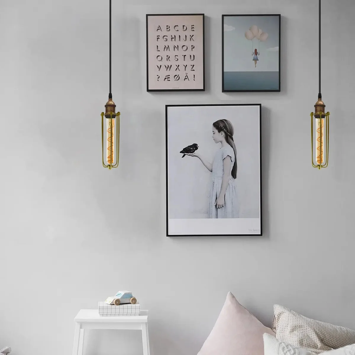 Brushed copper industrial pendant lamp with cylindrical wire cage shade hanging from adjustable cable