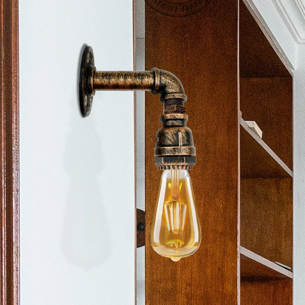 Retro industrial wall light with metal pipe design and vintage bulb, suitable for indoor decor in living or dining rooms