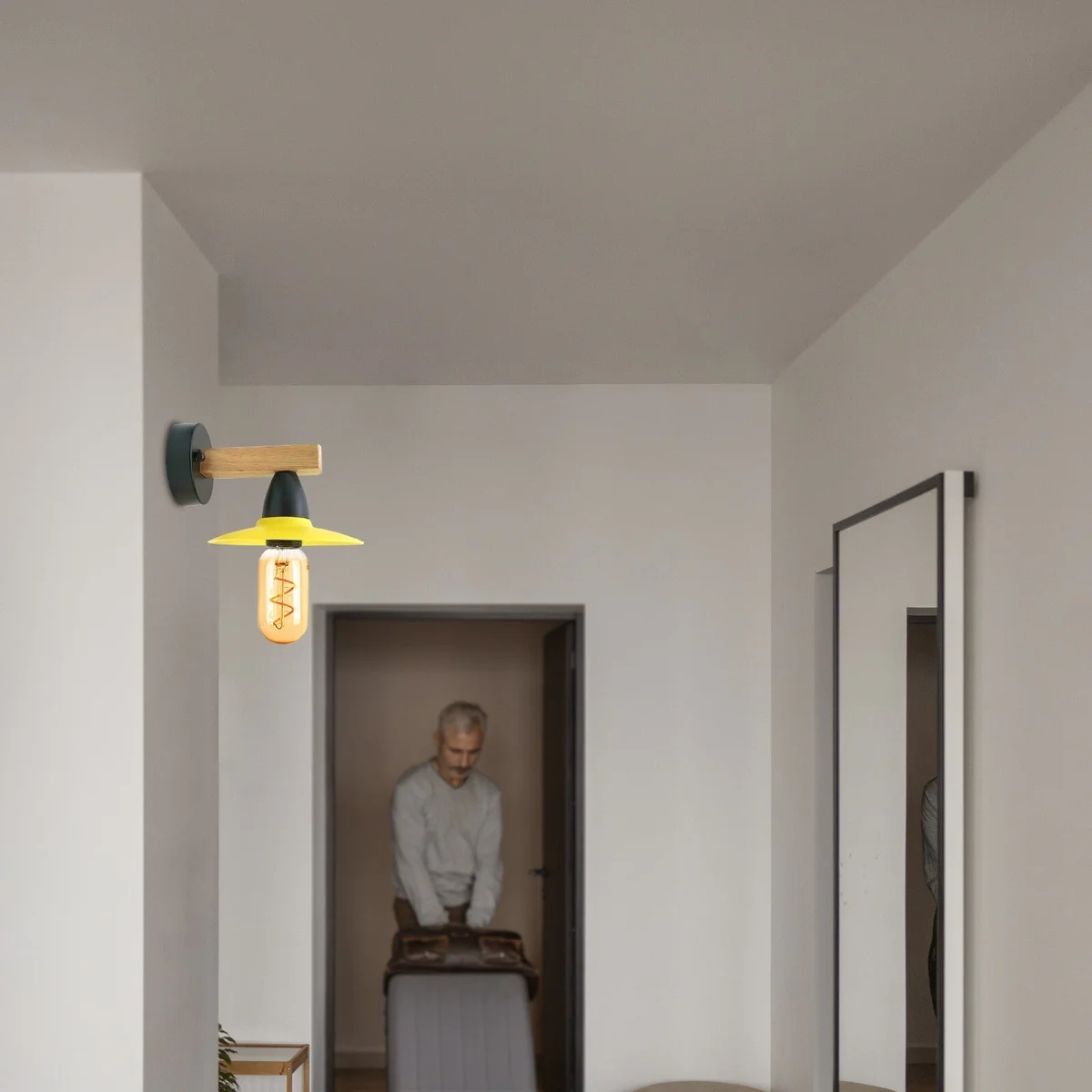 Modern industrial wall light with black metal frame and natural wood accent, E27 fitting, mounted on white wall