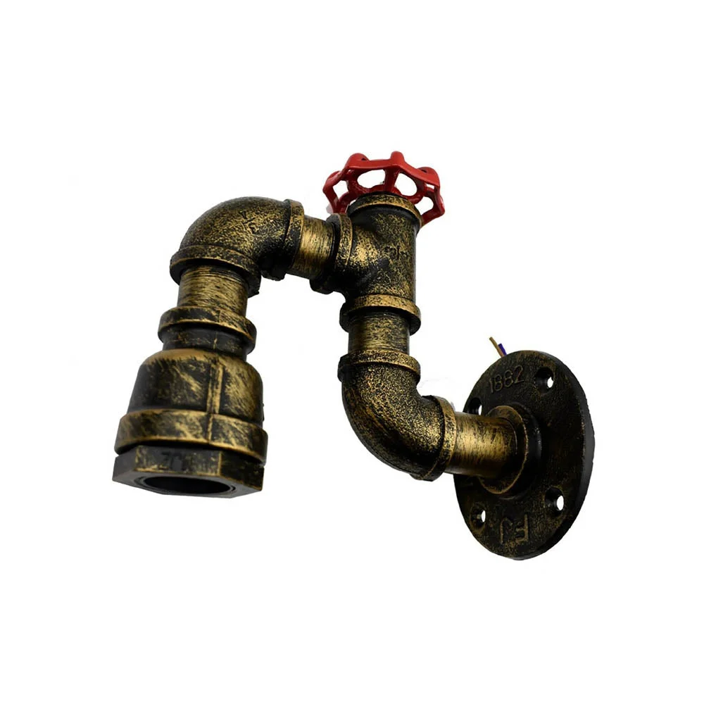 Steampunk pipe wall light in vintage brass finish mounted on brick wall, rustic indoor lamp for loft style decor