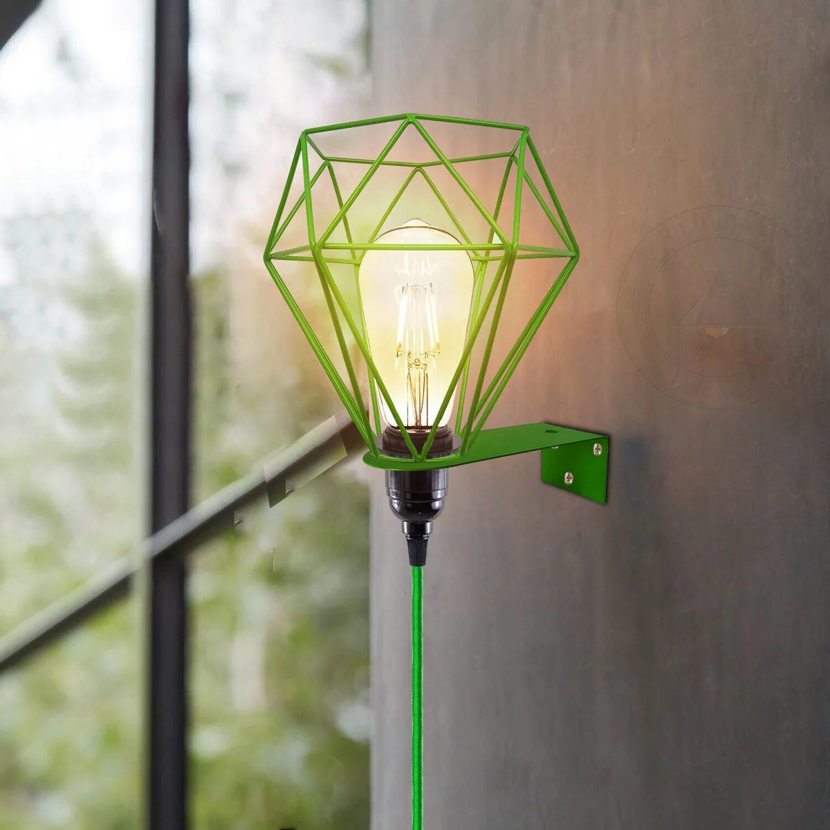 Green vintage wall light with metal diamond cage, a plug‑in fixture and slender cord, suited for living room decor.