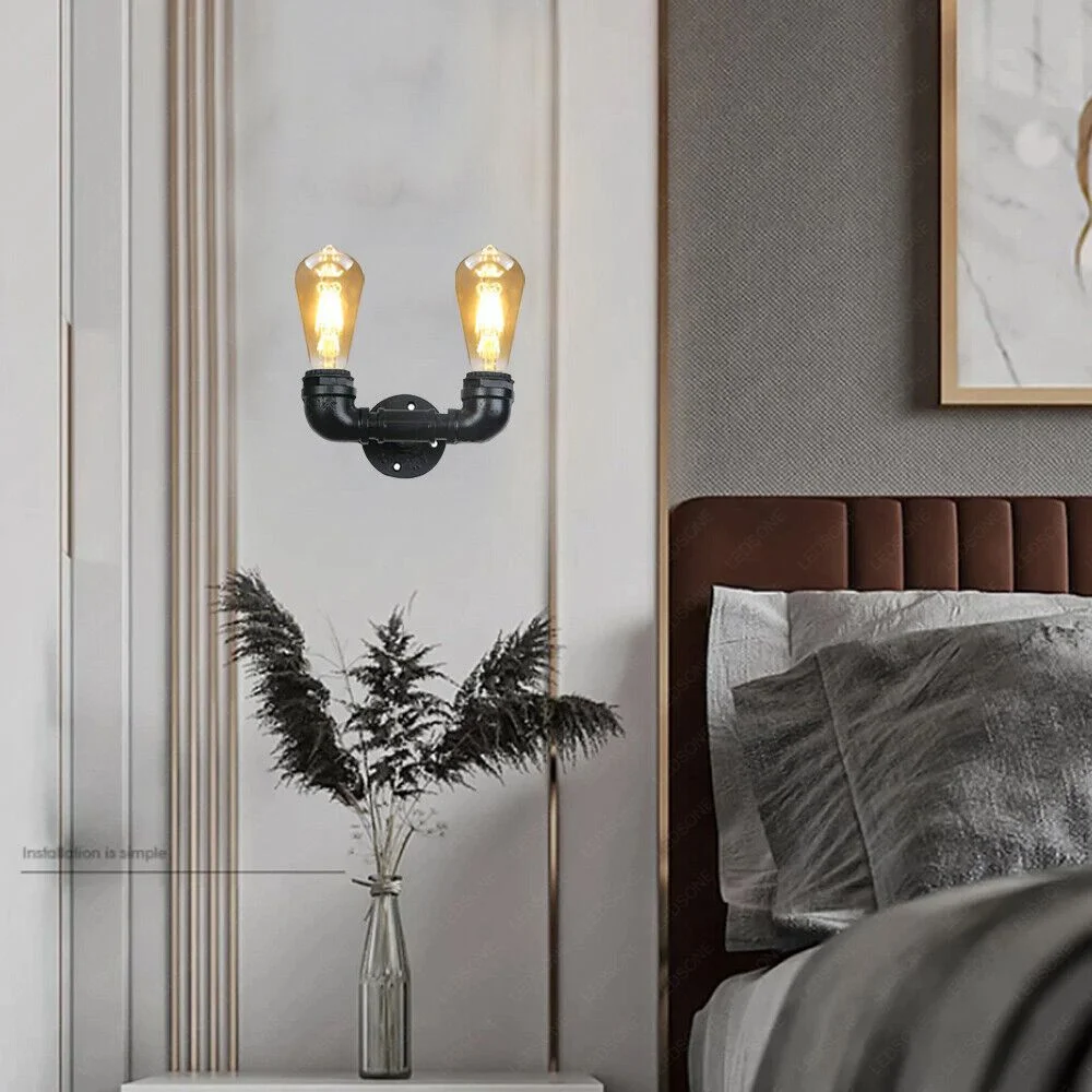 Twin black metal vintage wall sconce with adjustable waterpipe heads in steampunk style.