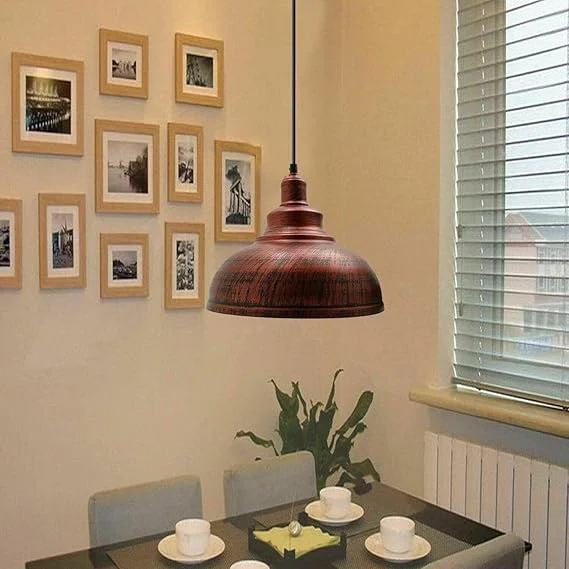 Rustic red curvy metal industrial pendant lampshade with E27 fitting shown from side angle on white background