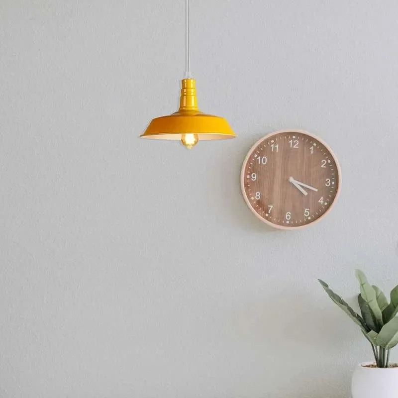 Yellow metal retro style easy fit ceiling shade with curved design and glossy finish hanging against white background