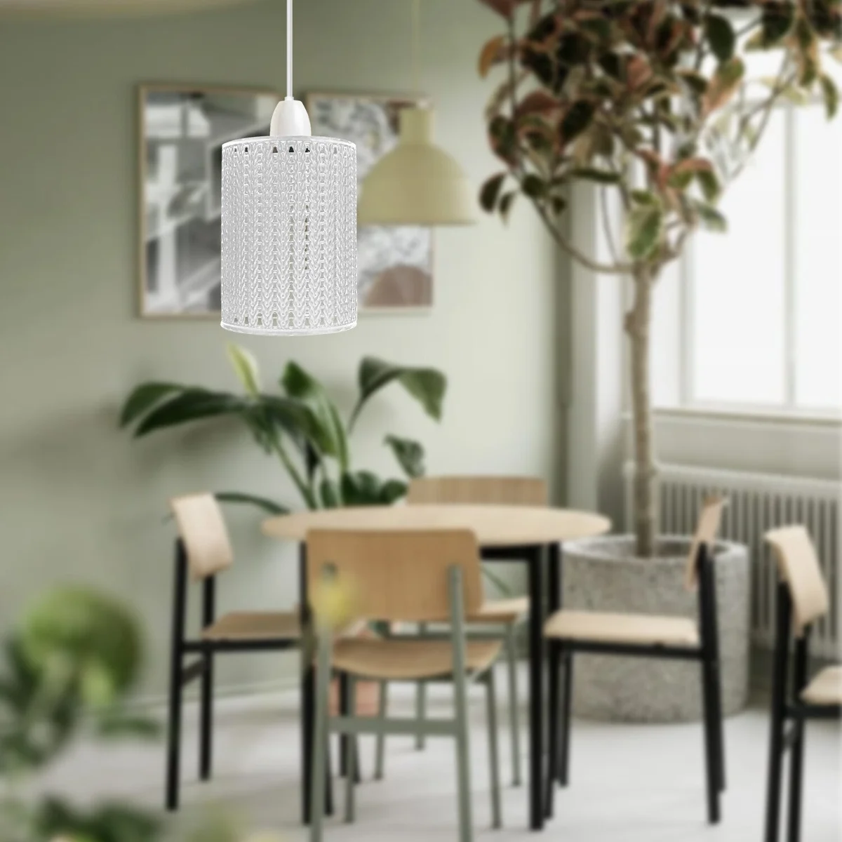White industrial metal lamp shade with open wire cage drum design, shown installed on a ceiling light socket