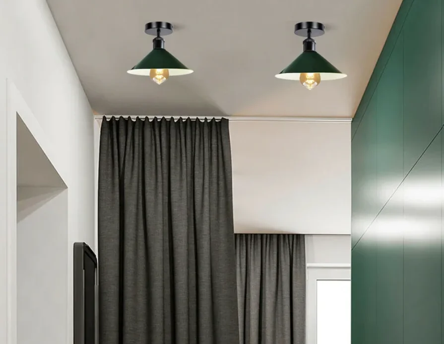 Vintage green lamp shade with cone design, metal build, shown hanging indoors with soft lighting background