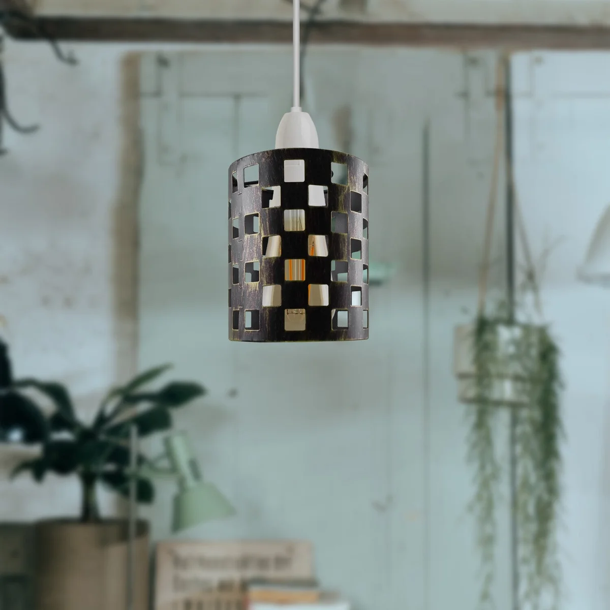 Brushed brass ceiling lampshade in modern industrial drum design, open metal wire cage diffuses light, no bulb shown