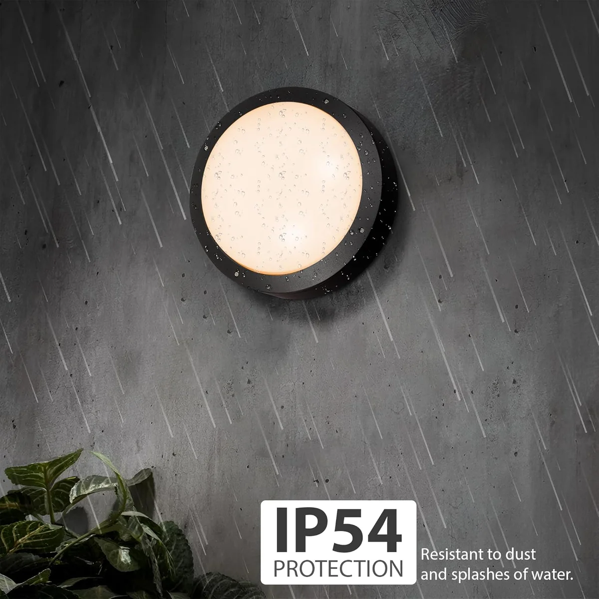 Two round IP54 outdoor bulkhead lights with warm white energy saving LED light mounted on a white wall