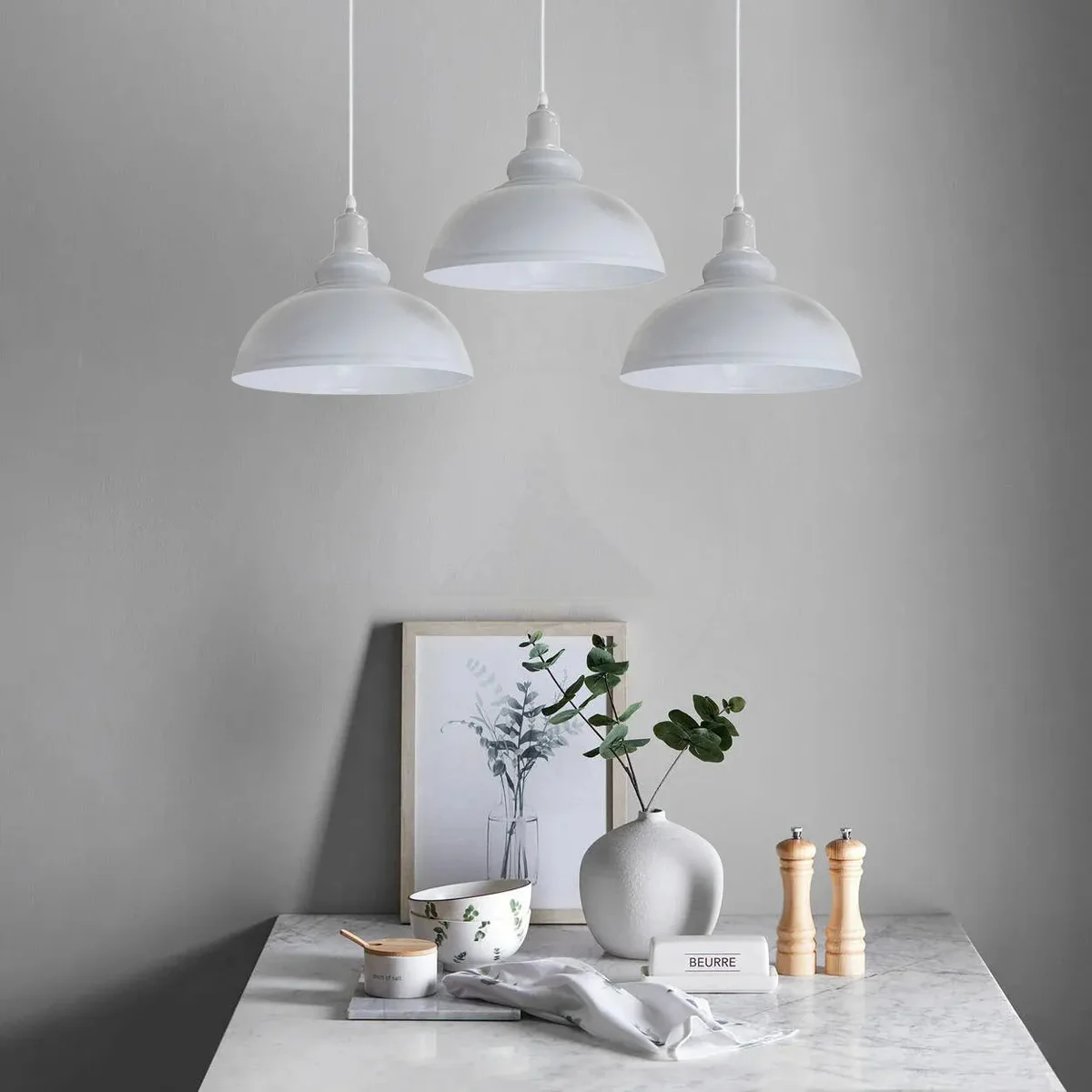 White vintage pendant light with three curvy metal and PVC shades hanging from adjustable cords