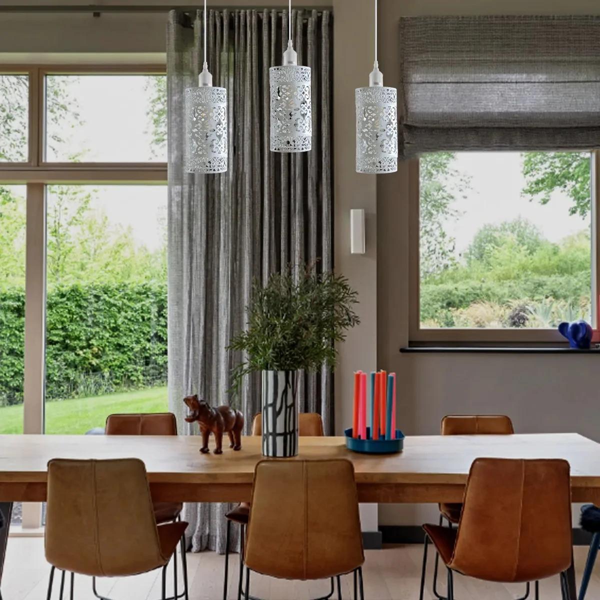 Three vintage pendant light fixtures with adjustable metal cage shades hanging from black cords against a white background