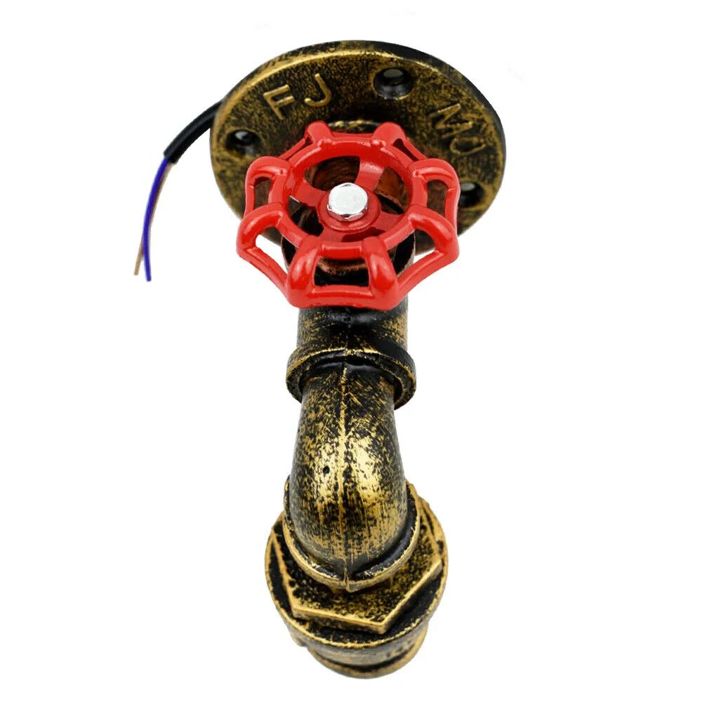 Steampunk wall light with vintage industrial metal pipes, red valve detail, and E27 bulb mounted on a wall in brushed brass finish