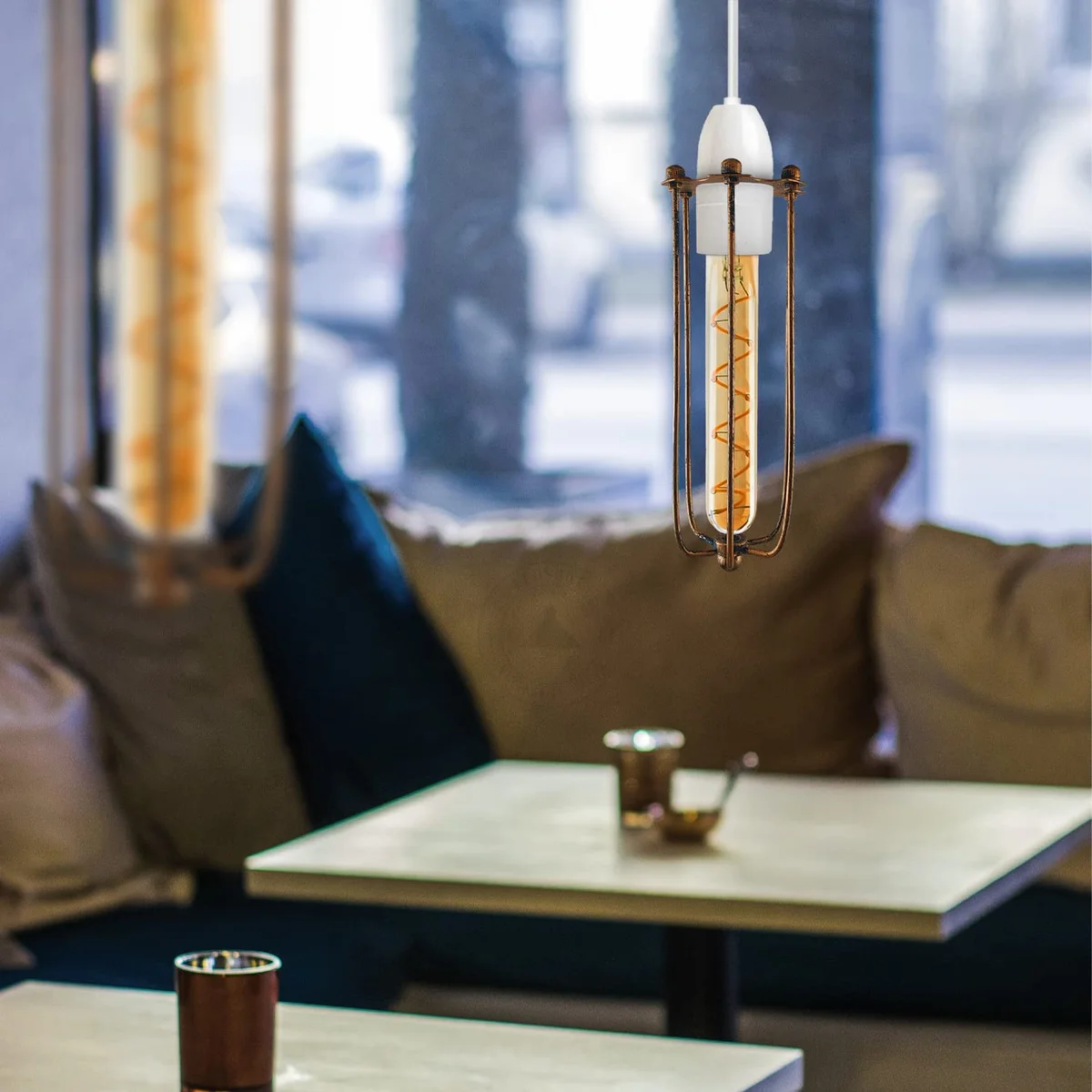 Brushed copper pendant light with long vintage industrial metal wire cage, slim cylindrical design, no bulb included