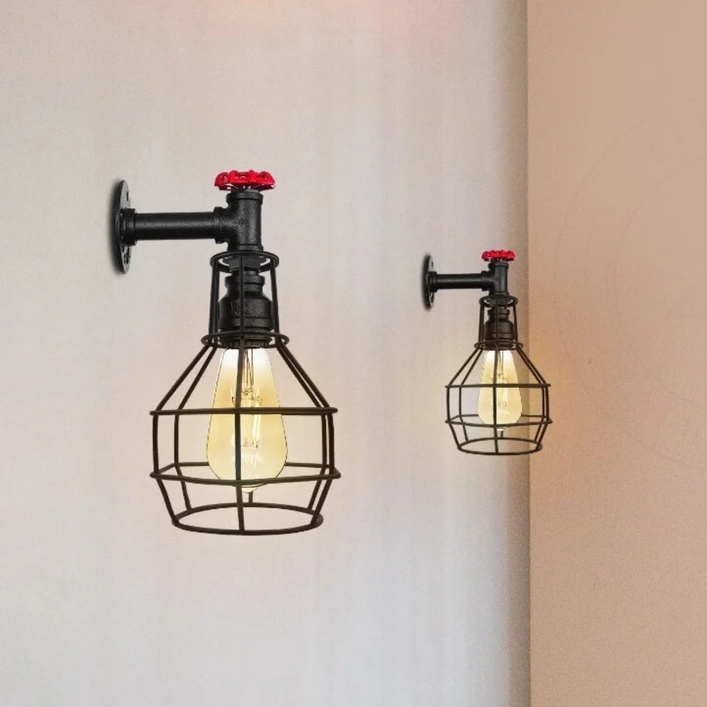 Black steampunk cage wall sconce with red valve, adjustable pulley, and vintage industrial pipe design on white background