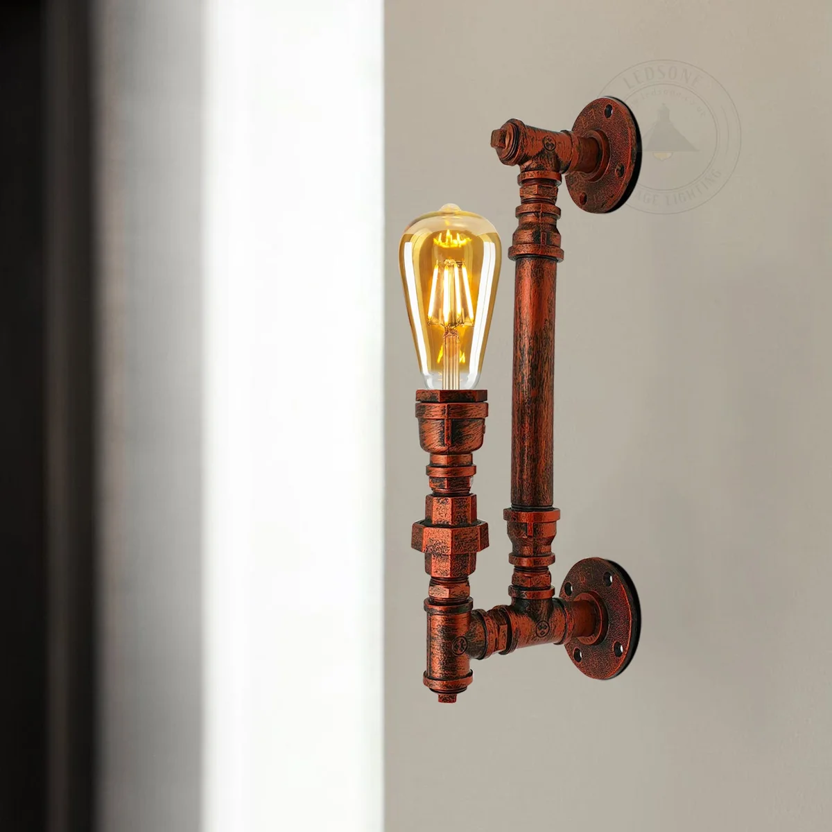 Retro style lamp with steampunk pipe design in brushed copper finish mounted on indoor wall lighting setting