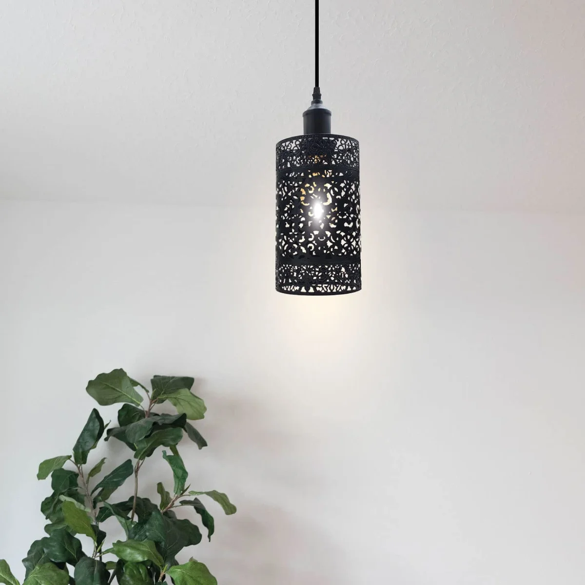 Black industrial metal pendant lampshade with open wire drum cage design and black finish, shown from side angle