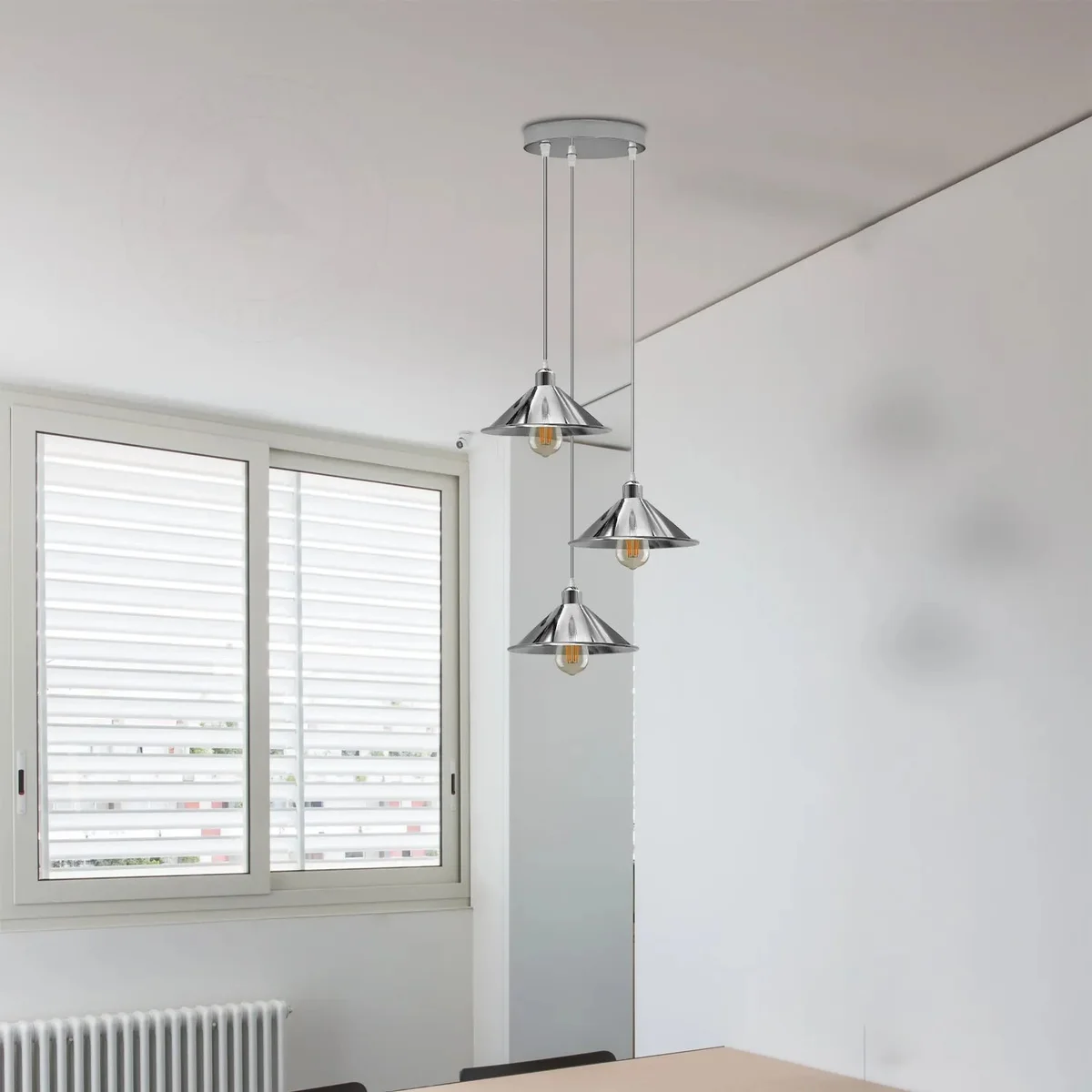 Three cone shade pendant light fixtures with chrome metal shades hanging from 95cm cords against a white background