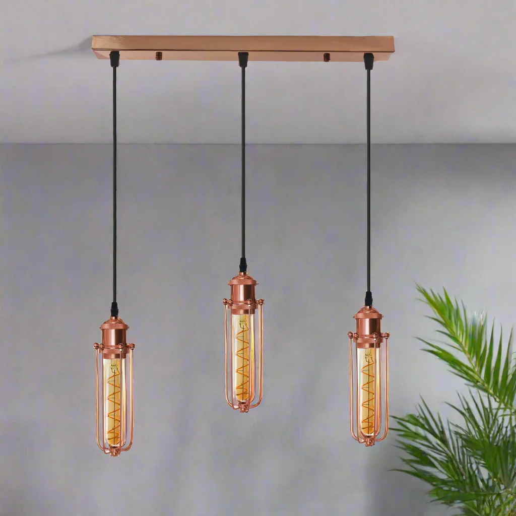 Rose gold pendant light with three rectangular wire cage shades hanging from black adjustable cords