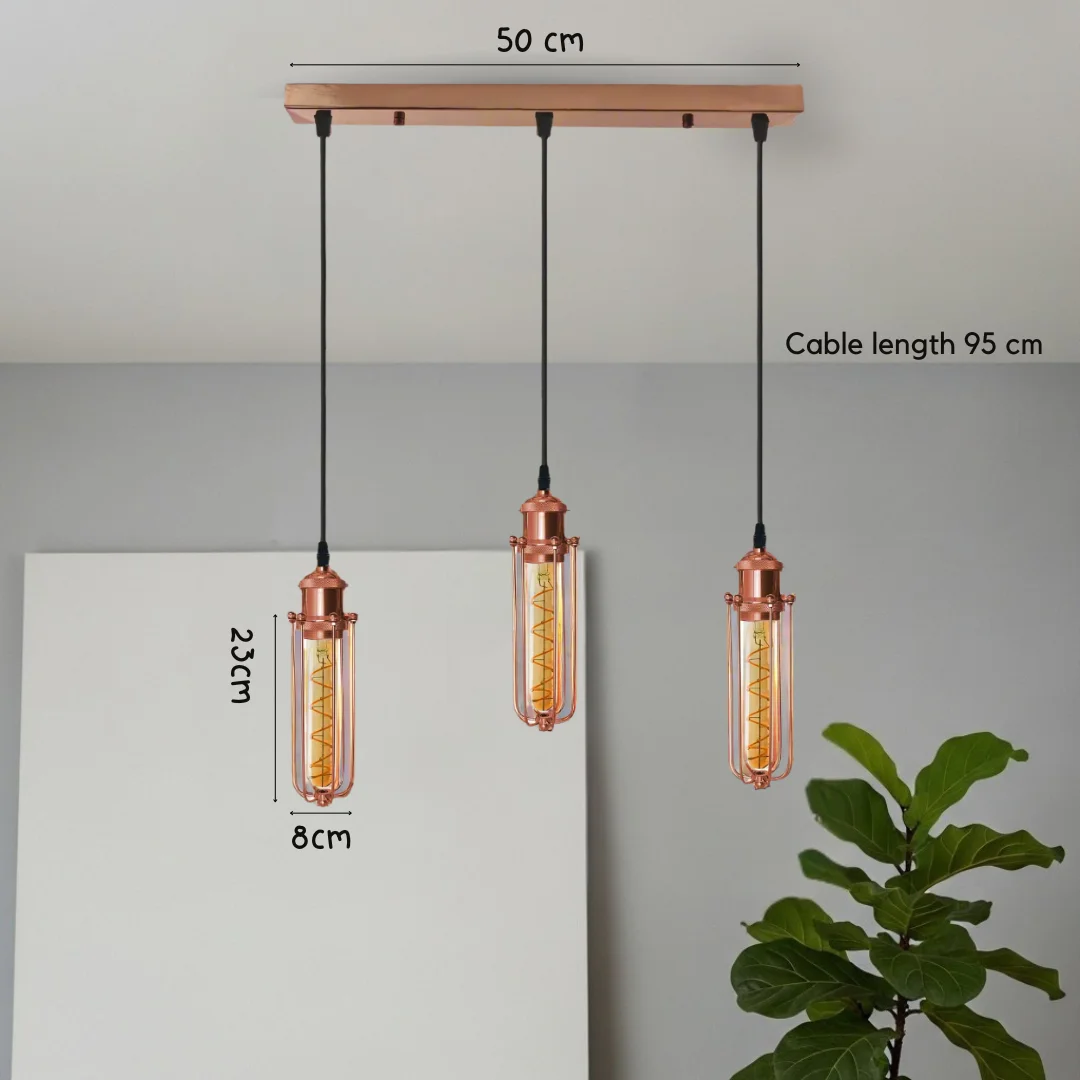 Rose gold 3 head pendant light with rectangular wire cage shades and adjustable black cords hanging from ceiling fixture