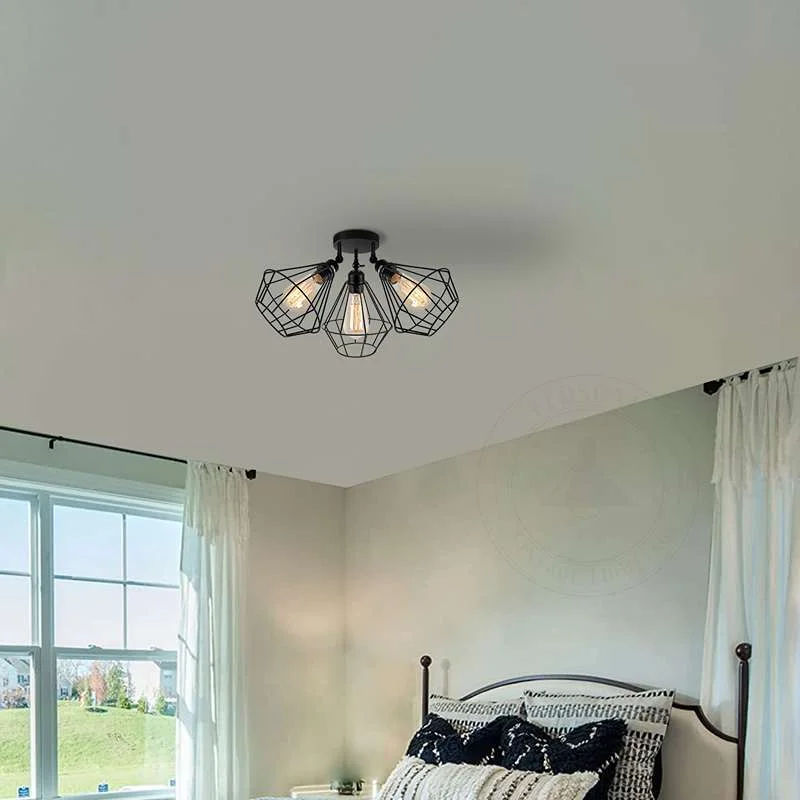 Black 3 head ceiling light with adjustable wire cage shades and metal finish, suitable for indoor use