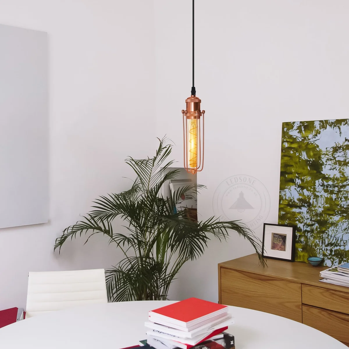 Rose gold pendant light with geometric metal cage and adjustable black hanging cord for indoor vintage lighting