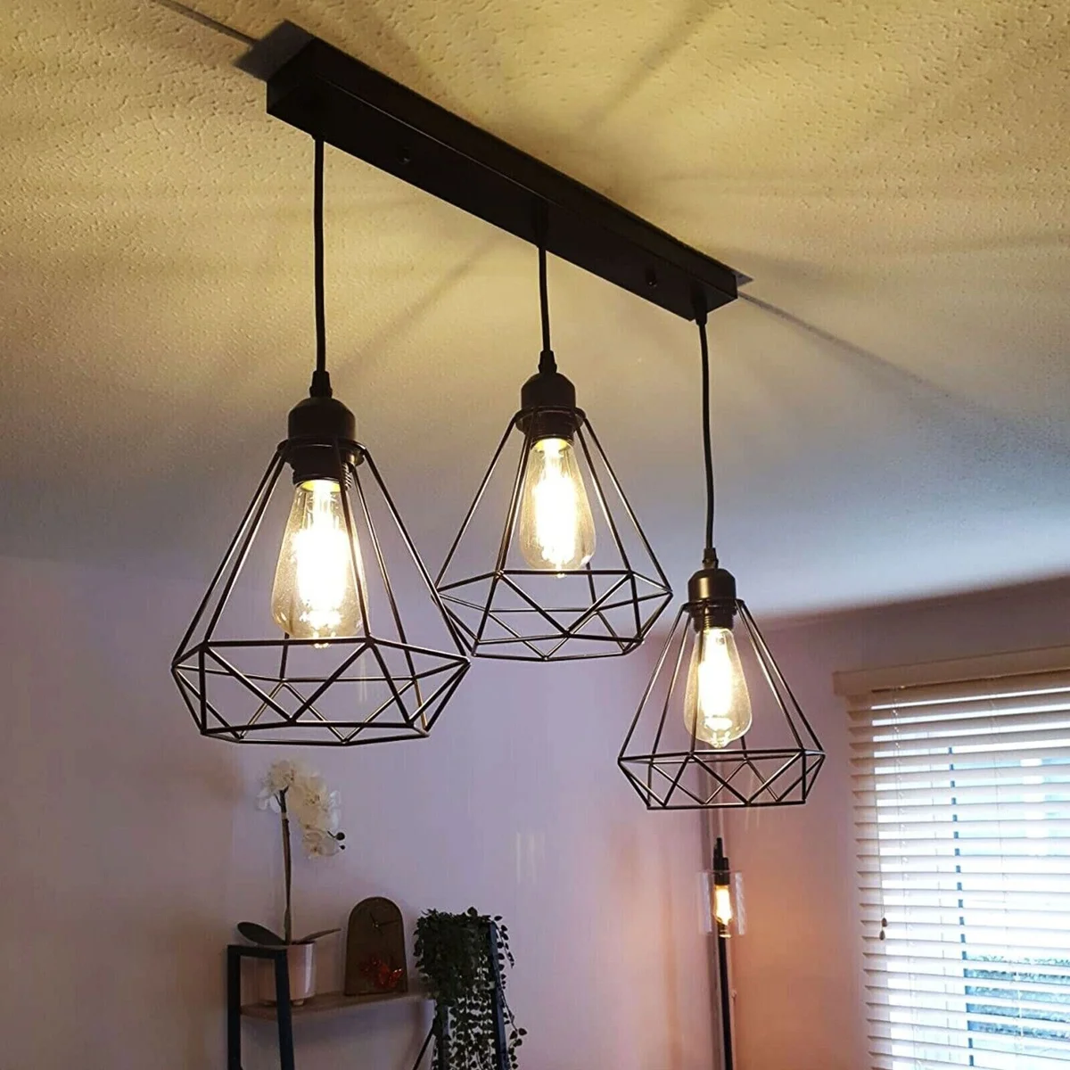 Contemporary painted wire cage shade in diamond shape, metal frame, designed to fit standard ceiling light sockets.