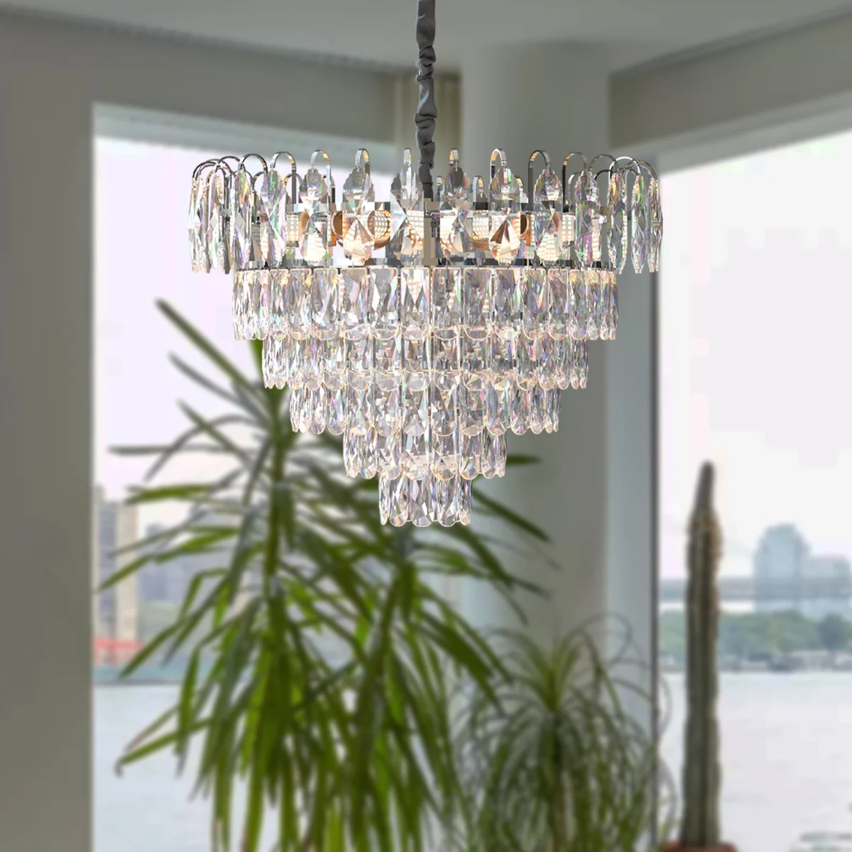 Modern chrome and gold chandelier with crystal droplets hanging from adjustable chain, round frame, ceiling mounted design