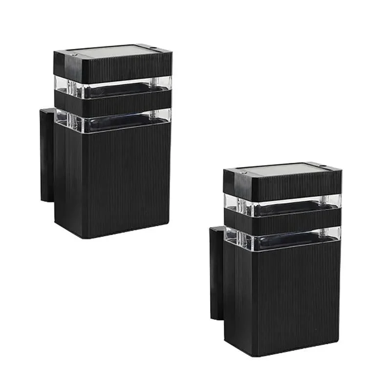 Modern black outdoor wall light mounted on exterior wall, casting warm white LED light with sleek square design