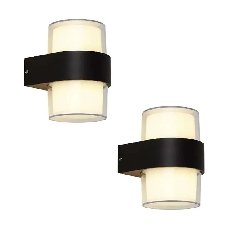 Modern black aluminum 12W LED outdoor wall light mounted on garden wall casting warm up and down illumination
